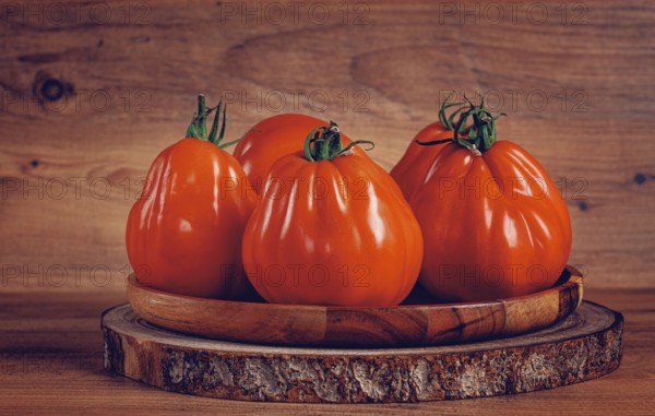Khinkali tomatoes, on a wooden cutting board, wooden background, no people