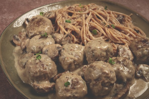 Spaghetti with meatballs and mushrooms, in cream sauce, homemade, no people