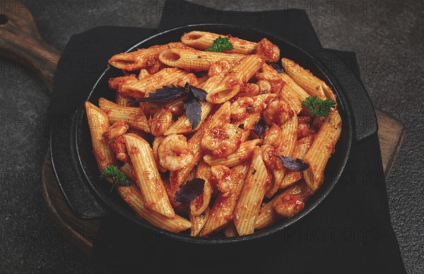 Penne pasta, with shrimp in tomato sauce, close-up, no people