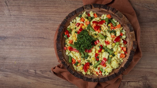 Couscous with vegetables, paprika, carrots, string beans, corn, homemade, top view, no people