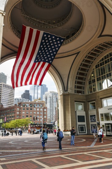 American flag fluttering, distinctive archway, Boston Harbor Hotel, Rowes Wharf, passers-by, walkers, Freedom Trail, Financial District, Downtown, Boston, Massachusetts, New England, USA