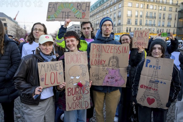 Activists from Fridays For Future holding cardboard signs at Fridays for Future rally on the tenth anniversary of the Paris Agreement at Pariser Platz, Berlin, 12.12.2025