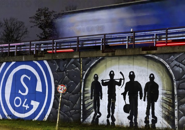FC Schalke 04 logo and mining motif at the A 42 Gelsenkirchen-Schalke motorway exit at night, North Rhine-Westphalia, Germany