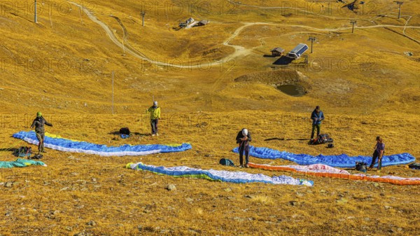 Paragliders prepare for launch, Corne de Sorebois summit, Val d'Anniviers, Valais Alps, Canton of Valais, Switzerland