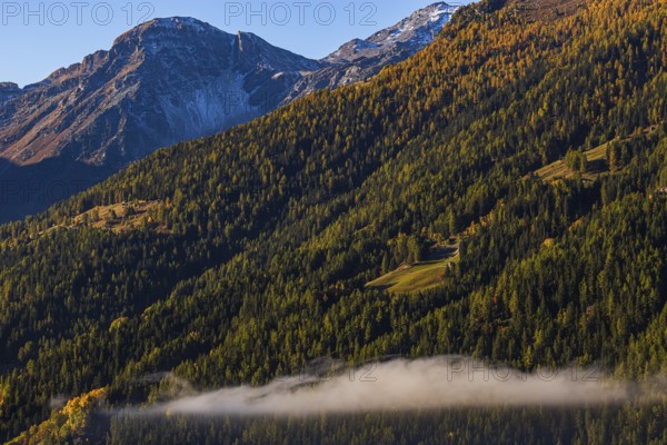 Fog rises over the mountain slopes of the Val d'Anniviers, Valais Alps, Canton of Valais, Switzerland