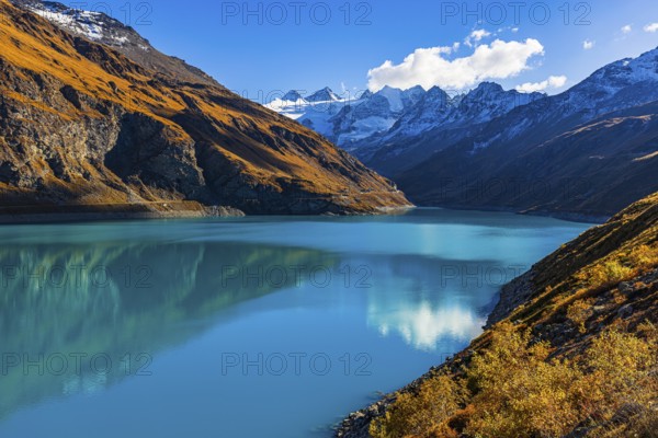 The Lac de Moiry reservoir, with the snow-capped peaks of the Grand Cornier, Tete Blanche and Pointe Moiry mountains, Val d'Anniviers, Valais Alps, Canton of Valais, Switzerland