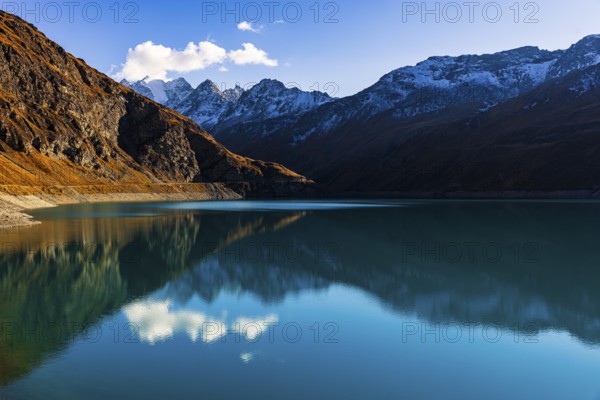 The turquoise Lac de Moiry reservoir, behind the peaks of the Grand Cornier, Tete Blanche and Pointe Moiry mountains, Val d'Anniviers, Valais Alps, Canton of Valais, Switzerland