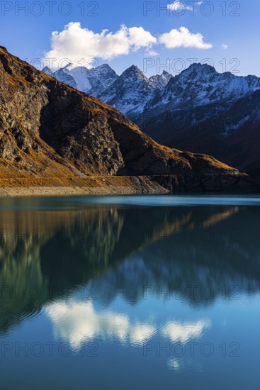The turquoise Lac de Moiry reservoir, behind the peaks of the Grand Cornier, Tete Blanche and Pointe Moiry mountains, Val d'Anniviers, Valais Alps, Canton of Valais, Switzerland