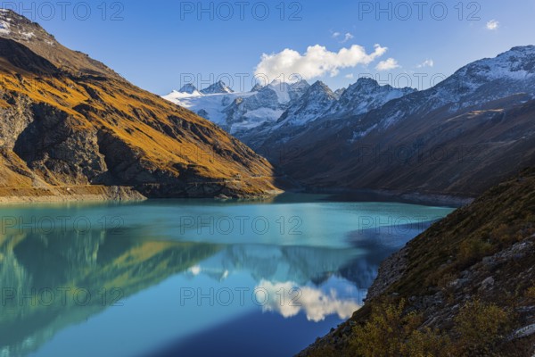 The turquoise Lac de Moiry reservoir, behind the snow-capped peaks of the Grand Cornier, Tete Blanche and Pointe Moiry mountains, Val d'Anniviers, Valais Alps, Canton of Valais, Switzerland