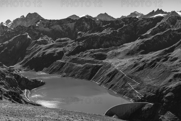 The Lac de Moiry reservoir with the dam, in the background the peaks of the Grand Cornier, Tete Blanche and Pointe Moiry mountains, black and white photo, Val d'Anniviers, Valais Alps, Canton of Valais, Switzerland