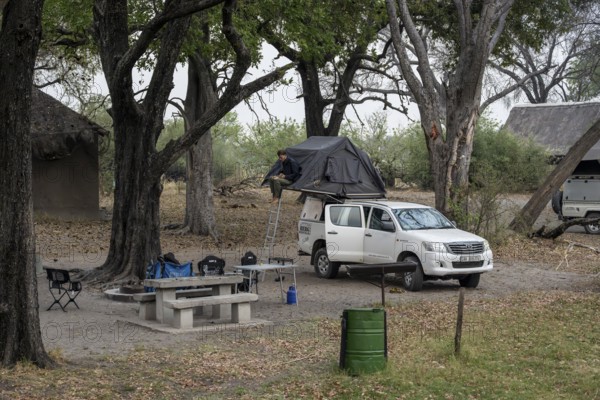 Campground, off-road car with roof tent, Xakanaxa, Moremi Game Reserve, Botswana