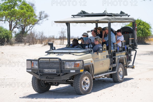 Safari car on safari with tourists in National Park, Savuti, Chobe National Park National Park, Botswana