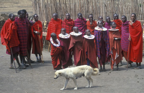 Maasai men and girls in their village, dog, Ngorongoro crater, Tanzania, Africa, June 2000, vintage, retro, old, historic