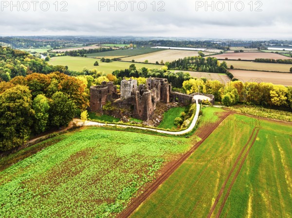 Autumn Colours over ruins of Goodrich Castle and River Wye from a drone, Goodrich, Herefordshire, England, United Kingdom