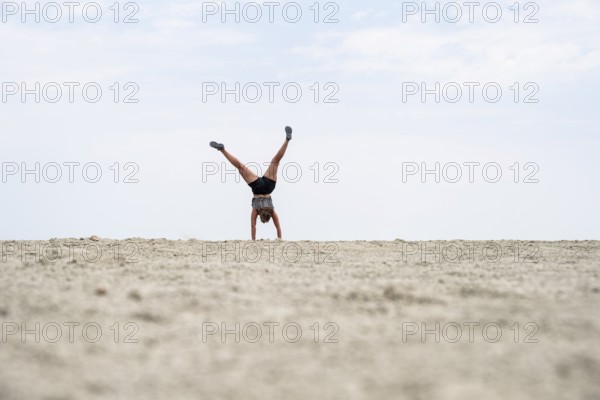 Abstract, woman doing gymnastics in a whirring landscape, Etosha pan, Etosha National Park, Namibia