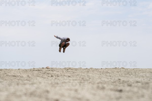 Abstract, man jumping at Etosha pan, salt pan, Etosha National Park, Namibia