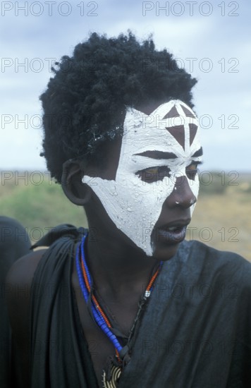Portrait of a Maasai boy with face painted white on the occasion of his initiation, Ngorongoro Crater, Tanzania, Africa, June 2000, vintage, retro, old, historical