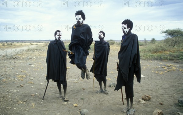 Maasai boys with white painted faces on the occasion of their initiation, showing traditional jumps, Ngorongoro Crater, Tanzania, Africa, June 2000, vintage, retro, old, historic