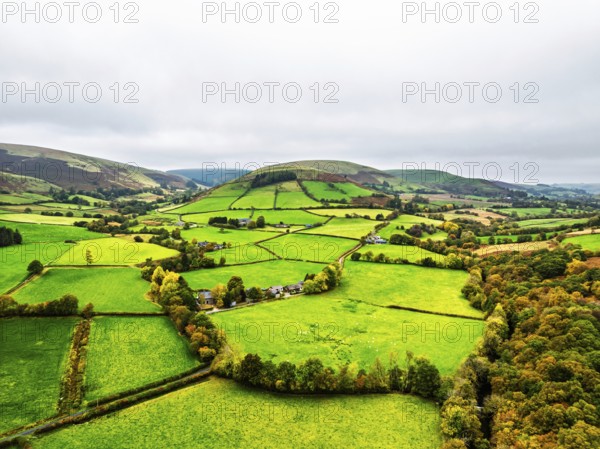Autumn colours of Farms over River Wye and Road A470 from a drone, Llanidloes, Powys, Montgomeryshire, Wales, UK