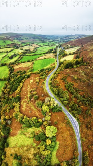 Autumn colours of Farms over River Wye and Road A470 from a drone, Llanidloes, Powys, Montgomeryshire, Wales, UK