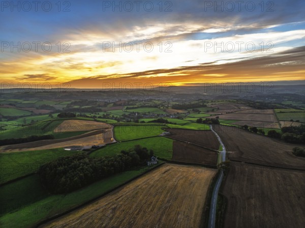 Sunset of Devon Farms and Fields over Berry Pomeroy from a drone, Totnes, England, United Kingdom