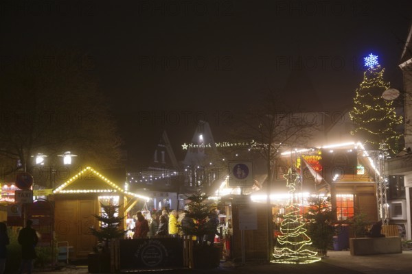A bright Christmas market at night with colorful lights and lively decoration, Winterberg, North Rhine-Westphalia, Germany