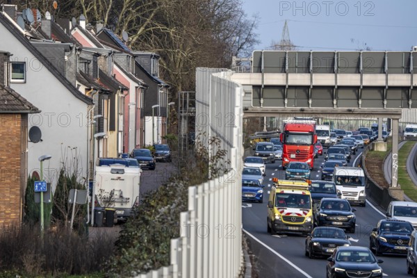 Residential buildings directly on the A40 motorway, noise barrier, heavy traffic near the Essen-Ost motorway junction, view to the west, 6-lane motorway, with 2 bus lanes in the middle, rush hour traffic, North Rhine-Westphalia, Germany
