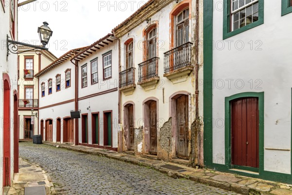 Strolling down the street among the colonial houses of the historic city of Ouro Preto, Ouro Preto, Minas Gerais, Brazil