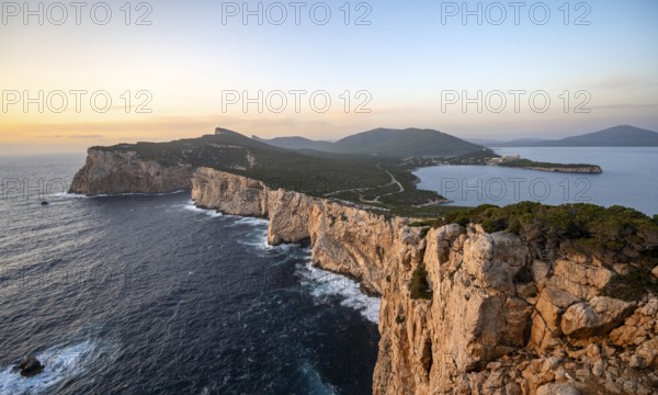 Coastal landscape at sunset, steep cliffs by the sea, cliffs in the evening light, Capo Caccia, Alghero, Sardinia