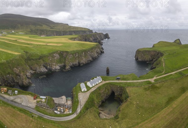 Aerial view of bay with small harbour and rock gate, Malin Beg, Malinbeg, County Donegal, Ireland