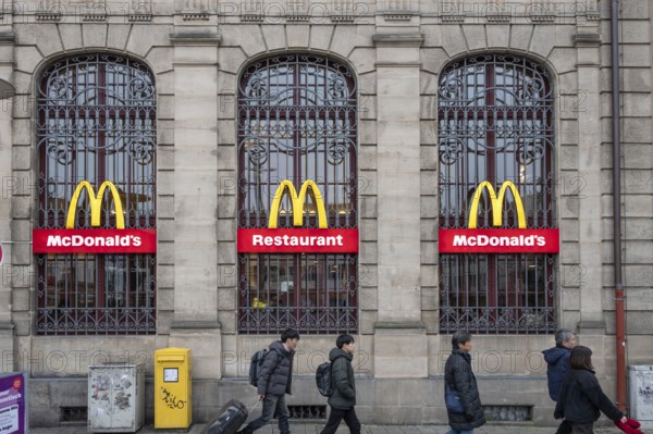 McDonald's logos on the historic lattice windows of the Old Post Office, Erlangen, Mittelfranklen, Bavaria, Germany