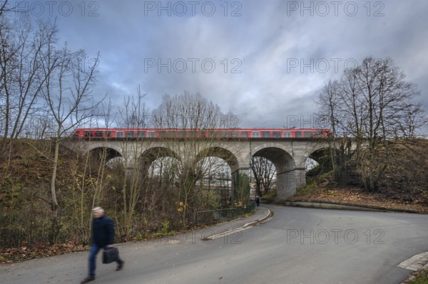 Regional train travels over the historic stone railway viaduct, built in 1876, Lauf an der Pegnitz, Middle Franconia, Bavaria, Germany