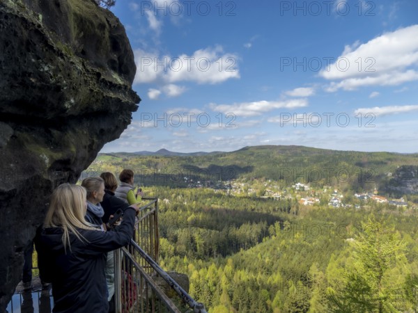 Hikers at a viewpoint with rocks, panoramic view of the landscape on Oybin, Zittau Mountains, things, Germany