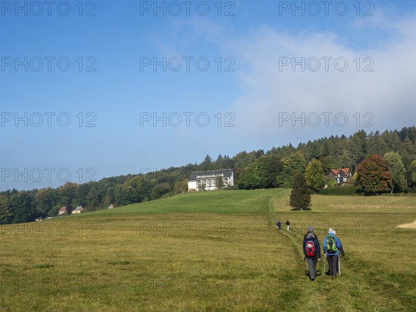 Landscape with meadows, forest and hiking group, Zittau Mountains, Saxony, Germany