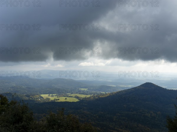 Dramatic weather with dark clouds over low mountain ranges, Bohemian Lusatia, Czech Republic