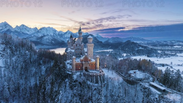 Neuschwanstein Castle at sunset with snowy mountains, Schwangau near Füssen, Ostallgäu, Allgäu, Bavaria, Germany