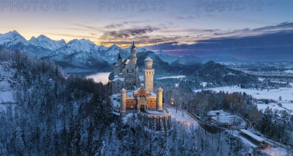 Neuschwanstein Castle at dusk in winter with mountain scenery, Schwangau near Füssen, Ostallgäu, Allgäu, Bavaria, Germany