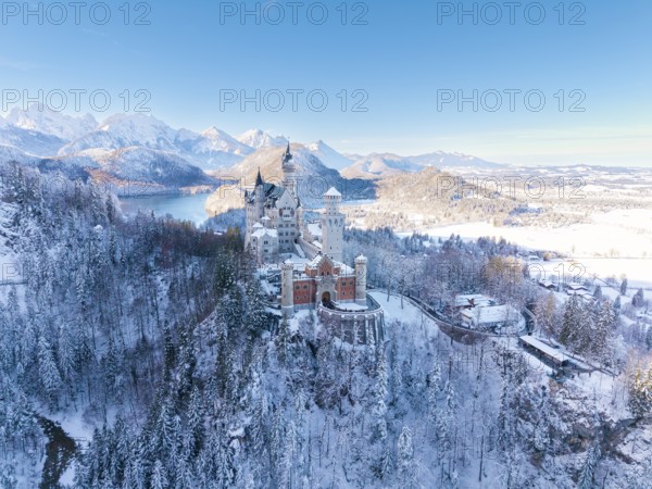 Winter landscape with Neuschwanstein Castle, surrounded by snow-covered forests and mountains, quiet atmosphere, Schwangau near Füssen, Ostallgäu, Allgäu, Bavaria, Germany