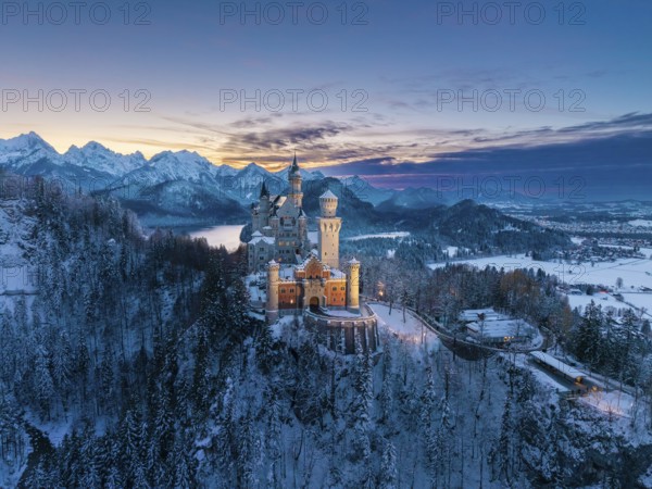 Picturesque Neuschwanstein Castle in winter at dusk with alpine panorama, Schwangau near Füssen, Ostallgäu, Allgäu, Bavaria, Germany