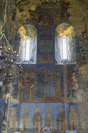 Historical wall paintings under windows in a bright church interior, Akhtala monastery, Akhtala town, Lorikeet province, Armenia