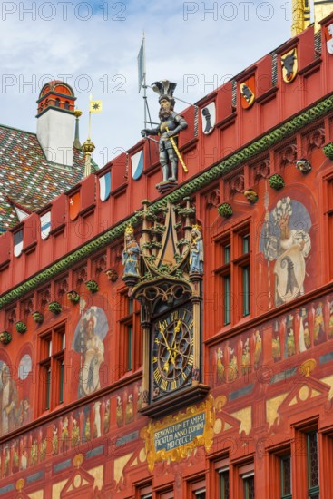 Exterior view with a magnificent clock at the Red Town Hall, Market Square, Basel