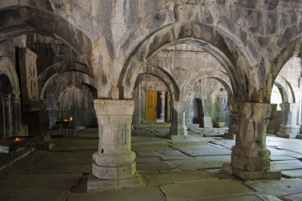 Ancient room with stone arches and yellow lighting creates a quiet, historic atmosphere, Sanahin monastery, Sanahin town, UNESCO World Heritage Site, Lorikeet province, Armenia