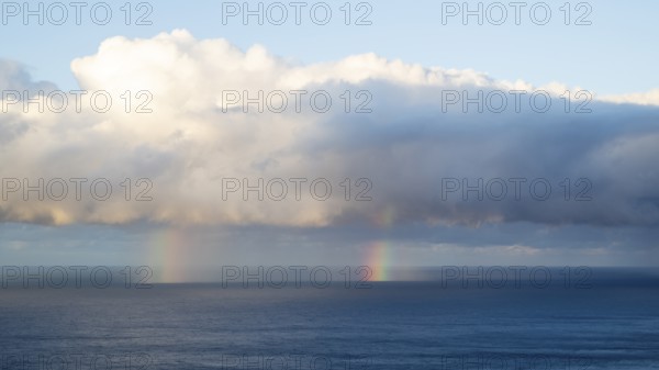 Rainbow over sea, dark rain cloud, rain, Madeira, Portugal