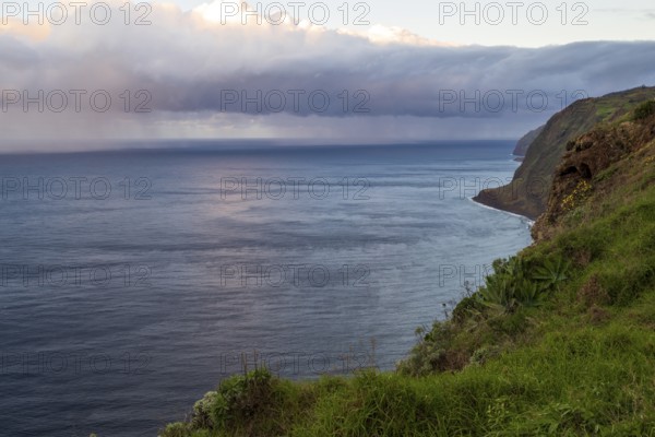 Sunset, rainbow over sea, at Farol da Ponta do Pargo lighthouse, west coast, Madeira, Portugal