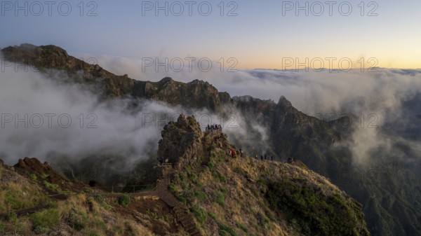 Sunrise at Pico do Arieiro, clouds of fog pass over mountain peaks, hiking trail PR1, Madeira, Portugal