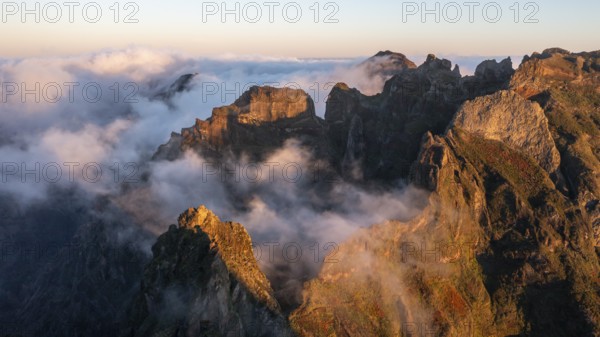 Aerial view, sunrise at Pico do Arieiro, clouds of fog sweeping over mountain peaks, Madeira, Portugal