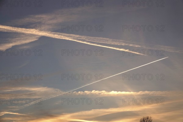 Picturesque evening sky with contrails, autumn, Germany