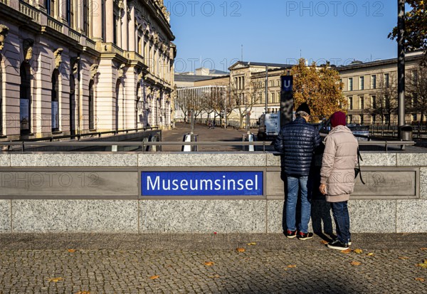 Tourists stand at the entrance to Museumsinsel train station in Berlin Mitte, Germany