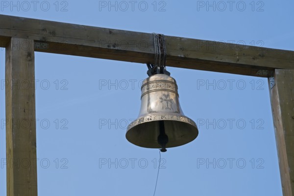 Metal bell on a wooden structure against a clear blue sky, Goshavank monastery, Tavush province, Armenia