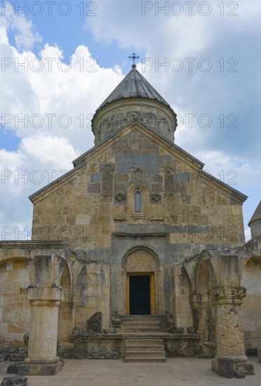 Front view of a stone church with distinctive entrance and tower in front of sky, Haghartsin monastery, Hagarzin, Tavush province, Armenia